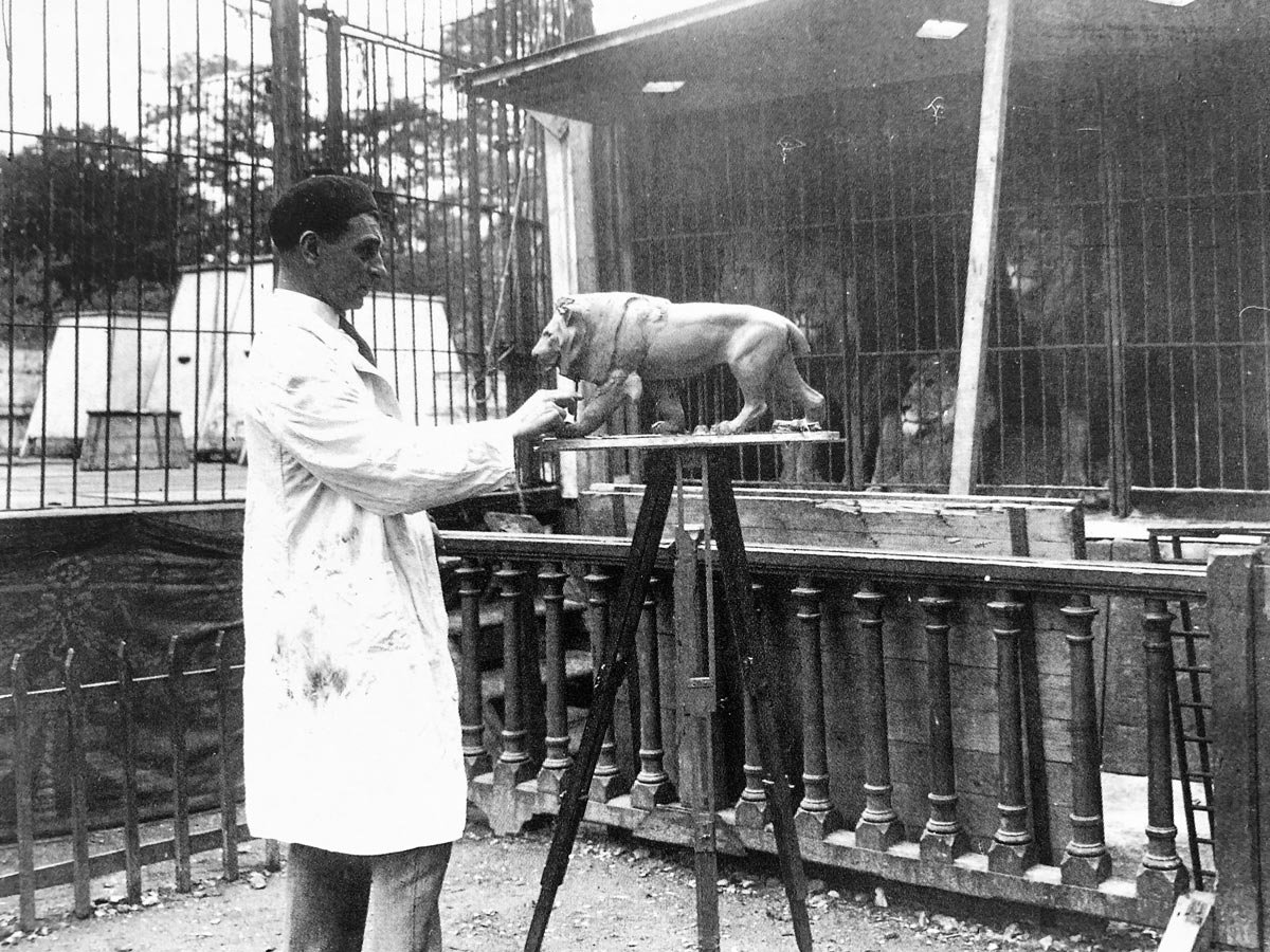 Max Le Verrier sculpting a lion in his Paris workshop, circa 1925.